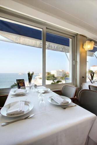 a white table with a view of the ocean at Le Rhul in Marseille