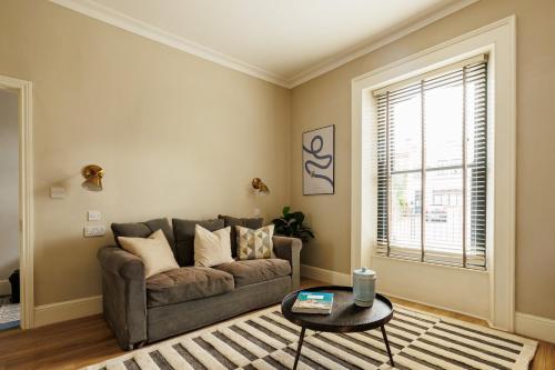 a living room with a couch and a table at GuestReady - Contemporary home with garden in Dublin