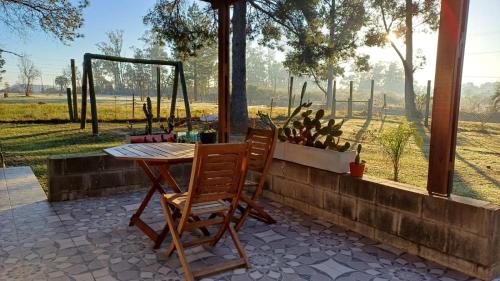 a table and two chairs on a patio at El Paraíso - Casa rural en zona termal de Concordia in Concordia