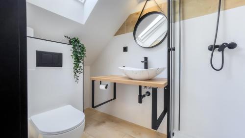 a bathroom with a sink and a mirror at apartmány Svätého Martina in Holíč