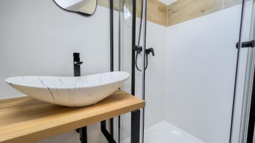 a bathroom with a vessel sink on a wooden counter at apartmány Svätého Martina in Holíč
