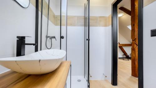 a bathroom with a white sink and a shower at apartmány Svätého Martina in Holíč