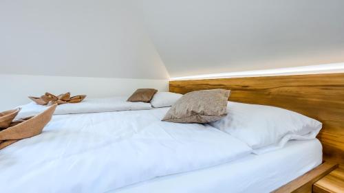 two beds in a room with white sheets and pillows at apartmány Svätého Martina in Holíč