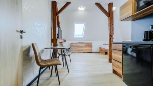 a kitchen with a table and chairs in a room at apartmány Svätého Martina in Holíč