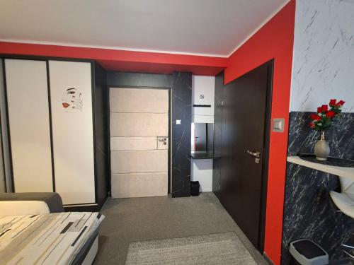 a room with a corridor with a door and red trim at HORTENSJA 100 in Koszalin