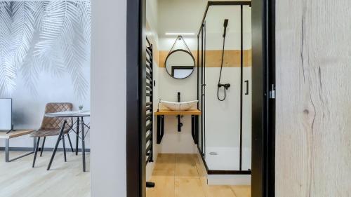a hallway with a door and a table and chair at apartmány Svätého Martina in Holíč