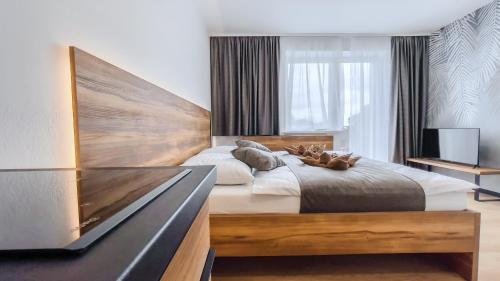 a bedroom with a large bed and a tv at apartmány Svätého Martina in Holíč