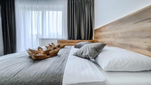a large bed with two pillows on top of it at apartmány Svätého Martina in Holíč