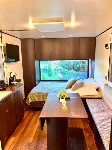 a bedroom with a bed and a table in a room at Lumobile in Gryfice