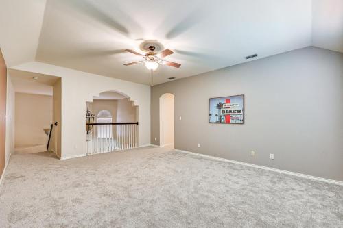 an empty living room with a ceiling fan at Private Theater and Pool Spacious Mission Home in Mission
