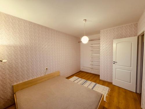 an empty room with a bed and a door at Munamäe tänav 16-5 in Otepää