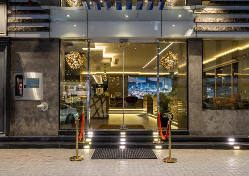 a store front of a building with glass doors at Gacine Hotel Tahlia فندق غسن التحلية in Medina