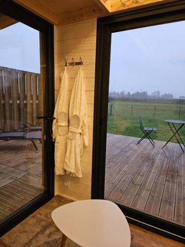 a room with a sliding glass door with a view of a deck at Tiny House avec Spa privatif in Boigny-sur Bionne