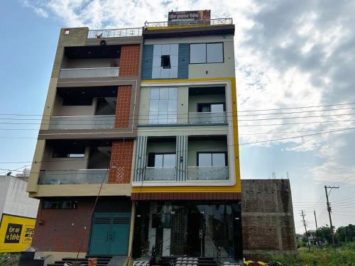 a tall building with a lot of windows at Hotel Moad Mudgal Palace in Godarpura