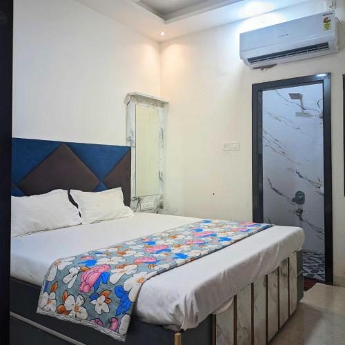 a bedroom with a large bed with a blue headboard at Hotel Moad Mudgal Palace in Godarpura