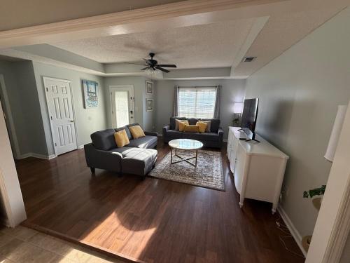 a living room with a couch and a table at Spacious 3BR Home Sleeps 12 Near Valdosta in Hahira