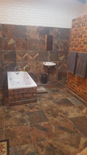 a bathroom with a bath tub and a sink at Mountain Guesthouse in Pretoria