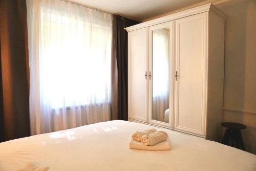a bedroom with a bed with a towel on it at Casa Luna in Zalău