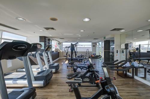 a gym with lots of treadmills and cardio machines at Park Inn by Radisson Berrini in Sao Paulo