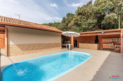 a swimming pool in the backyard of a house at Casa Gruta do Macaco - MA02I in Solemar