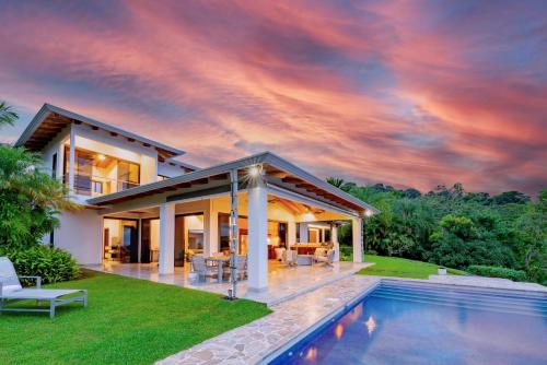 a house with a pool in front of it at Hacienda Jaguar - by Pura Villas in Ojochal