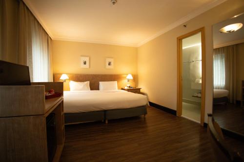 a hotel room with a bed and a television at Park Inn by Radisson Berrini in Sao Paulo