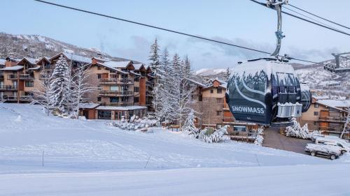a ski lift in front of a lodge in the snow at Crestwood 1211 Standard Studio Loft in Snowmass Village