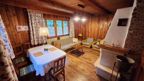 a living room with a white table and a fireplace at Chata u Hagrida in Štrba