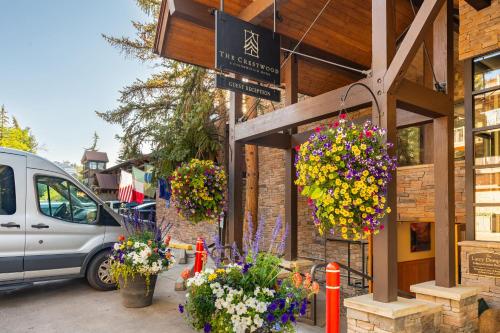 a building with lots of flowers in front of it at Crestwood 2309 Deluxe 1 Bedroom plus Loft in Snowmass Village