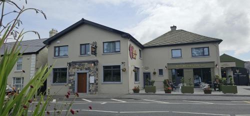 a building on a street next to a street at The Monks Quarters in Quin