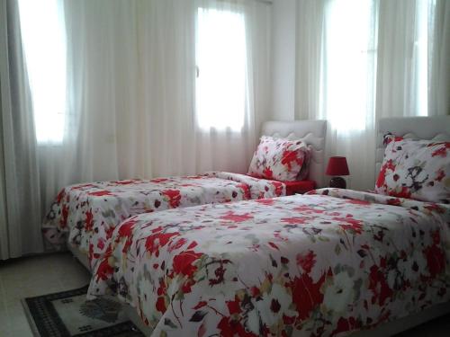 a bedroom with two beds with red and white covers at Holiday Home Turkuaz in Oludeniz