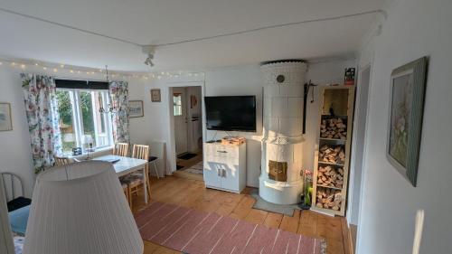 a living room with a heater and a dining room at Beautiful Idhult 2 in Aneby