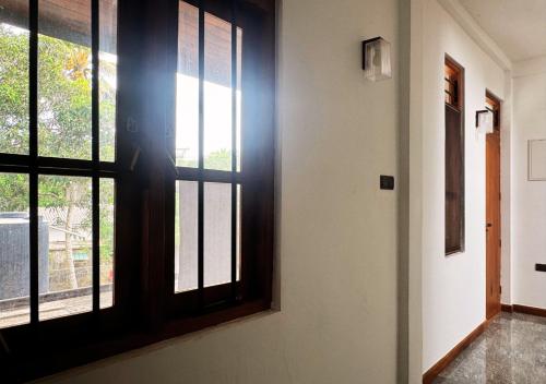 a room with a door and a window at Kings Town Hotel in Anuradhapura