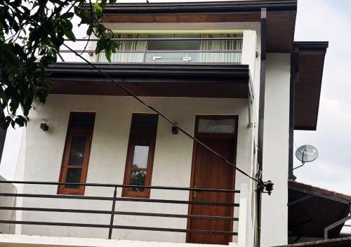 a white house with brown doors and windows at Kings Town Hotel in Anuradhapura