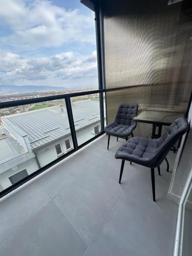 a balcony with two chairs and a table on a building at Luxury Jacuzzi Apartment City View Free Parking in Skopje