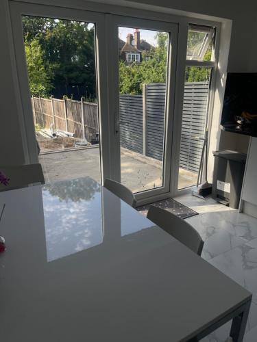 a kitchen with a table and a window with a view at London En-Suites in Hendon