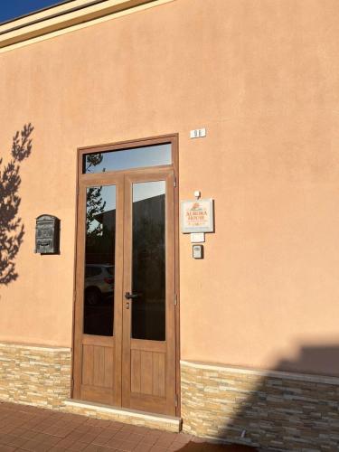 a door to a building with a sign on it at Aurora House in Càbras