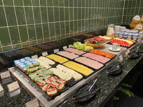 a table with many different types of food on it at Park Inn by Radisson Berrini in Sao Paulo