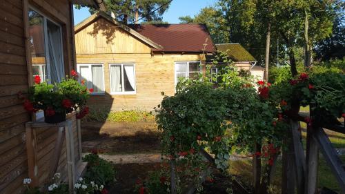 a house with flowers in front of it at Apartment Magnolija in Jūrmala