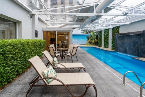 a patio with a table and chairs next to a swimming pool at Intercity São Paulo Nações Unidas in Sao Paulo