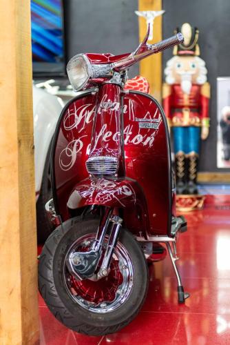 a red scooter is parked on a table at Castle Queen in Coseley