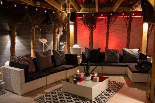 a living room with couches and a table and trees at Castle Queen in Coseley