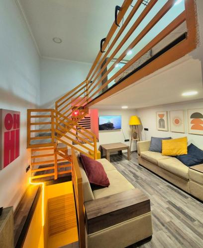 a living room with a staircase and a couch at Orange House, City-Center Stay in Tbilisi City