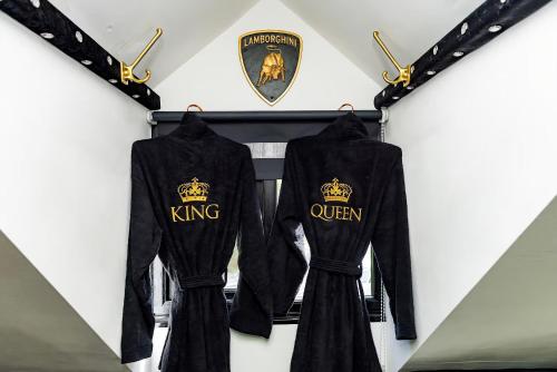two black velvet shirts hanging on a wall at Castle Queen in Coseley