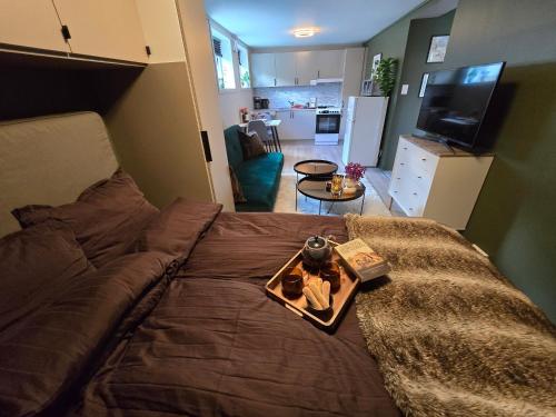 a bedroom with a bed with a tray on it at Nature vibe apartment Tromsø - Free Parking in Tromsø