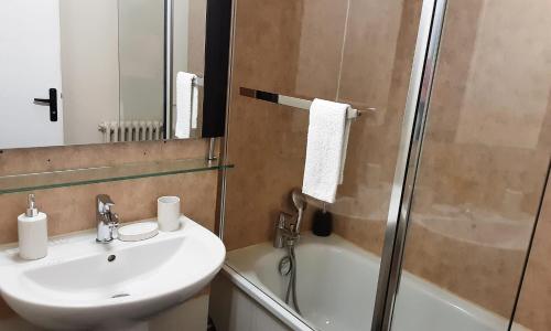 a bathroom with a sink and a shower at Room Urban Chic in Reims