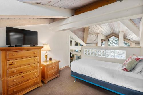 a bedroom with a bed and a dresser with a tv at Crestwood 3102 Standard 3 Bedroom Plus Loft in Snowmass Village