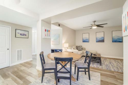 a dining room and living room with a table and chairs at 2BR w King Bed Pool Steps to Forest Park CWE in Tower Grove
