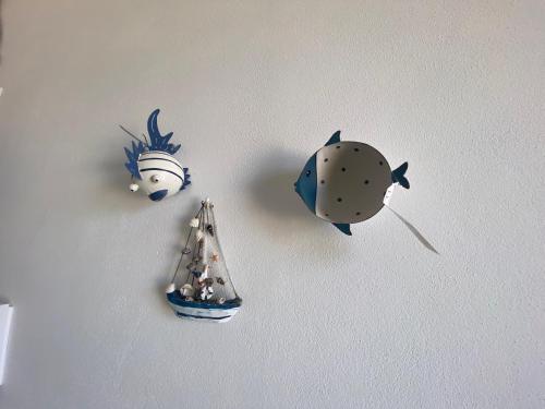 a wall with four fish decorations on a wall at PHI-Lampara in Santa Flavia