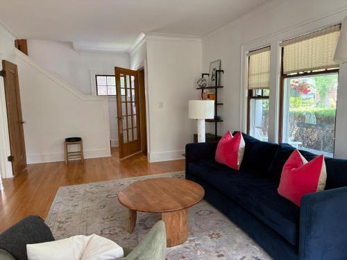 a living room with a blue couch and a table at 3 bedroom home next to downtown and medical mile in Grand Rapids
